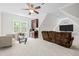 Bonus room with cozy seating, mini fridge, and bar for entertaining, bathed in natural light at 109 San Juan Dr, Chapel Hill, NC 27514