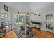Bright dining area with three large windows, stylish chandelier, and seating for four at 109 San Juan Dr, Chapel Hill, NC 27514
