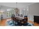 Formal dining room with a wood table, area rug, chandelier, and large windows at 109 San Juan Dr, Chapel Hill, NC 27514