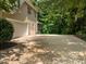 Wide driveway with ample parking space leads to a two-car garage, adjacent to a well-kept lawn at 109 San Juan Dr, Chapel Hill, NC 27514