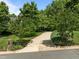 Long, paved driveway leading to a private residence surrounded by lush trees and landscaping at 109 San Juan Dr, Chapel Hill, NC 27514