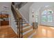 Elegant entryway featuring hardwood floors, a staircase with wrought iron, and a bright front door at 109 San Juan Dr, Chapel Hill, NC 27514