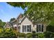 Beautiful home exterior with stone accents, well-manicured landscaping, and a charming facade at 109 San Juan Dr, Chapel Hill, NC 27514