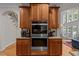 A kitchen featuring stainless steel double ovens and wooden cabinets at 109 San Juan Dr, Chapel Hill, NC 27514
