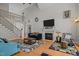 Spacious living room featuring a fireplace, staircase, and comfortable seating at 109 San Juan Dr, Chapel Hill, NC 27514