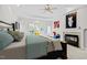 Comfortable main bedroom featuring a fireplace, ceiling fan, and access to the outdoors at 109 San Juan Dr, Chapel Hill, NC 27514