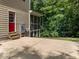 Paved patio with access to a screened-in porch and backyard, perfect for outdoor enjoyment and relaxation at 109 San Juan Dr, Chapel Hill, NC 27514