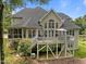 Expansive rear exterior view showcases the deck, stairs, and covered patio area at 109 San Juan Dr, Chapel Hill, NC 27514