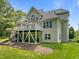 Back of house showcasing large deck and outdoor entertaining space, and green yard at 109 San Juan Dr, Chapel Hill, NC 27514