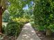 Inviting walkway through lush landscaping, creating a serene and picturesque entrance to the home at 109 San Juan Dr, Chapel Hill, NC 27514