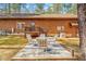 Cozy backyard patio with stone pavers, dining set, and exterior view of log cabin home at 1101 Dimmocks Mill Rd, Hillsborough, NC 27278