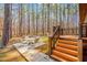 Backyard patio with an outdoor dining set, situated next to a wooden deck and steps at 1101 Dimmocks Mill Rd, Hillsborough, NC 27278