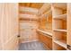Wooden walk-in closet with adjustable shelving for optimal storage at 1101 Dimmocks Mill Rd, Hillsborough, NC 27278