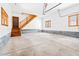 Large garage with stairs leading to the upper floor with ample space for storage at 1101 Dimmocks Mill Rd, Hillsborough, NC 27278