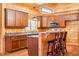 Kitchen featuring a breakfast bar, stainless steel microwave, and a window over the sink at 1101 Dimmocks Mill Rd, Hillsborough, NC 27278