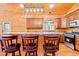 Charming log cabin kitchen with a breakfast bar, wood cabinets, and stainless steel appliances at 1101 Dimmocks Mill Rd, Hillsborough, NC 27278