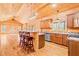 Spacious log cabin kitchen with wooden cabinets, stainless steel appliances, and breakfast bar at 1101 Dimmocks Mill Rd, Hillsborough, NC 27278