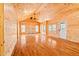 Large, bright living room with wooden walls, floors, and stone fireplace at 1101 Dimmocks Mill Rd, Hillsborough, NC 27278