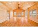 Spacious living room with vaulted ceilings, wood paneling, and large windows at 1101 Dimmocks Mill Rd, Hillsborough, NC 27278