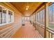 Inviting log cabin features a charming, expansive porch with wood railings and forest views at 1101 Dimmocks Mill Rd, Hillsborough, NC 27278
