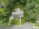 An aerial view of a charming home with mature trees and a spacious backyard with a circular patio at 111 Canberra Ct, Cary, NC 27513