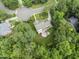 Aerial view of house situated on a cul-de-sac, boasting manicured landscaping and towering trees at 111 Canberra Ct, Cary, NC 27513