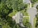 Aerial shot of a home with meticulously landscaped backyard, fire pit, and verdant surroundings at 111 Canberra Ct, Cary, NC 27513