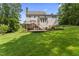 Expansive backyard featuring a deck, patio, and lush green lawn, ideal for outdoor enjoyment at 111 Canberra Ct, Cary, NC 27513