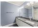 Elegant bathroom featuring double sinks, granite countertops, and a large mirror with modern lighting at 111 Canberra Ct, Cary, NC 27513