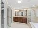Bright bathroom with glass shower, closet, double sinks, granite counters, and tile floors at 111 Canberra Ct, Cary, NC 27513