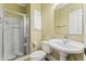 This bathroom has a walk-in shower with glass doors, vanity and toilet at 111 Canberra Ct, Cary, NC 27513