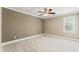 Bright bedroom with plush carpeting, neutral walls, ceiling fan and a large window at 111 Canberra Ct, Cary, NC 27513