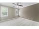 Comfortable bedroom with plush carpeting, neutral walls, a ceiling fan, and natural light streaming through the windows at 111 Canberra Ct, Cary, NC 27513