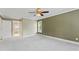 Bright bedroom with a ceiling fan, plush carpeting, and an adjoining bathroom with natural light at 111 Canberra Ct, Cary, NC 27513