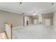 Expansive bonus room with plush carpeting, ceiling fan, and access to laundry closet and separate storage at 111 Canberra Ct, Cary, NC 27513