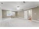 Versatile bonus room with neutral tones, plush carpeting, a ceiling fan, and plenty of natural light at 111 Canberra Ct, Cary, NC 27513