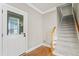 Welcoming entryway with a staircase and access to the outdoors through a glass door at 111 Canberra Ct, Cary, NC 27513