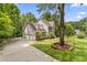 Two-story home with brick and siding exterior, attached garage, and landscaped front yard with mature trees at 111 Canberra Ct, Cary, NC 27513