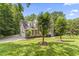 Charming two-story home with a well-manicured lawn and mature trees surrounding the property at 111 Canberra Ct, Cary, NC 27513