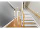Bright foyer featuring hardwood floors, staircase with wooden handrail, and neutral paint palette at 111 Canberra Ct, Cary, NC 27513