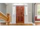 A view of the beautiful wood front door, sidelights and staircase at 111 Canberra Ct, Cary, NC 27513