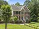 Charming two-story brick home with a well-manicured lawn and mature trees, perfect for Gathering living at 111 Canberra Ct, Cary, NC 27513