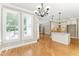 Open kitchen featuring granite countertops, white cabinetry, and modern lighting at 111 Canberra Ct, Cary, NC 27513