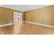 Living room with hardwood floors and a view of the fireplace through the French doors at 111 Canberra Ct, Cary, NC 27513