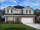 Charming two-story home showcases a brick-accented facade, attached garage, and well-manicured lawn at 1142 Winding Spring Dr, Mebane, NC 27302