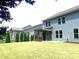 Spacious backyard with a lush lawn, privacy fence, and screened-in porch, ideal for relaxation and entertaining at 1205 Capstone Dr, Durham, NC 27713