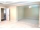 Large carpeted bedroom features neutral walls, white trim, and open doorway to another living space at 1205 Capstone Dr, Durham, NC 27713