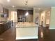 Spacious kitchen features a large island with granite countertops, dark wood cabinets, and stainless steel appliances at 1205 Capstone Dr, Durham, NC 27713