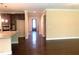 Open concept living room boasts hardwood floors and flows into a hallway with a view of the front door at 1205 Capstone Dr, Durham, NC 27713