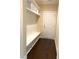 Practical mud room with built-in bench, storage shelves, and a convenient entry door at 1205 Capstone Dr, Durham, NC 27713